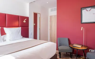 Un ou plusieurs lits dans un hébergement de l'établissement Logis Hôtel Le Tilia