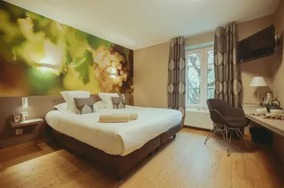 Un ou plusieurs lits dans un hébergement de l'établissement Auberge de Clochemerle - Spa & Restaurant gastronomique étoilé