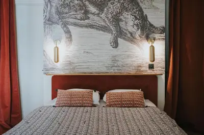 Un ou plusieurs lits dans un hébergement de l'établissement Lyon Country House - Suites & Tour de Garde