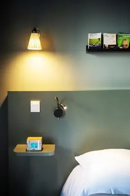 Un ou plusieurs lits dans un hébergement de l'établissement Hotel Beaulieu Lyon Charbonnières