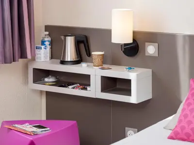 Un ou plusieurs lits dans un hébergement de l'établissement Kyriad Hotel Lyon Givors