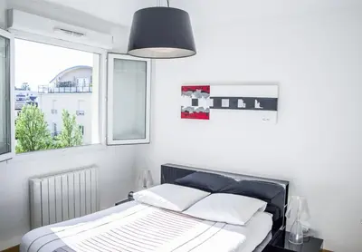Un ou plusieurs lits dans un hébergement de l'établissement Appart'cosy Lyon Est
