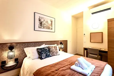 Un ou plusieurs lits dans un hébergement de l'établissement Hôtel Tête d'or