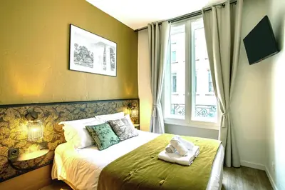 Un ou plusieurs lits dans un hébergement de l'établissement Hôtel Tête d'or