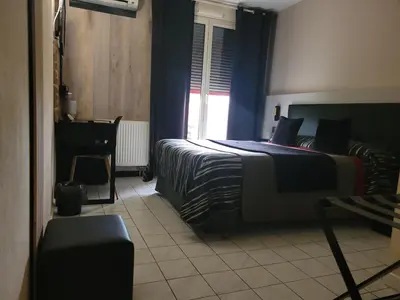 Un ou plusieurs lits dans un hébergement de l'établissement Hotel Médicis