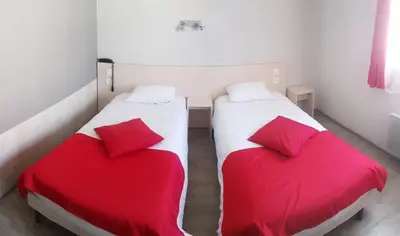 Un ou plusieurs lits dans un hébergement de l'établissement Hôtel La Bérangère