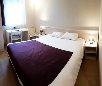 Un ou plusieurs lits dans un hébergement de l'établissement Hôtel La Bérangère