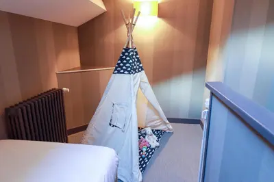 Un ou plusieurs lits dans un hébergement de l'établissement Hôtel Alexandra