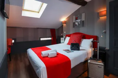 Un ou plusieurs lits dans un hébergement de l'établissement Hôtel Alexandra