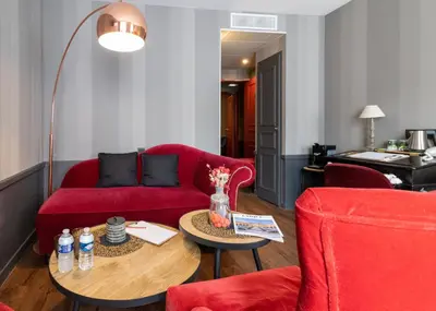 Coin salon dans l'établissement Hôtel Alexandra