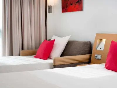 Un ou plusieurs lits dans un hébergement de l'établissement Novotel Lyon Gerland Musée des Confluences