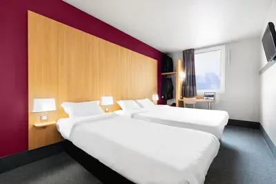 Un ou plusieurs lits dans un hébergement de l'établissement B&B HOTEL Lyon Vénissieux
