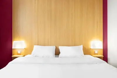 Un ou plusieurs lits dans un hébergement de l'établissement B&B HOTEL Lyon Vénissieux