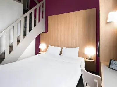 Un ou plusieurs lits dans un hébergement de l'établissement B&B HOTEL Lyon Vénissieux
