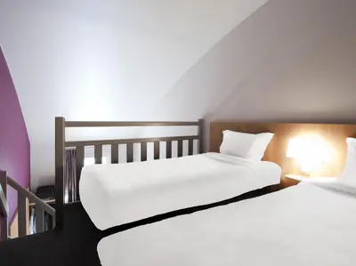 Un ou plusieurs lits dans un hébergement de l'établissement B&B HOTEL Lyon Vénissieux