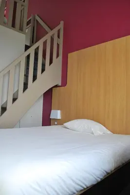 Un ou plusieurs lits dans un hébergement de l'établissement B&B HOTEL Lyon Vénissieux
