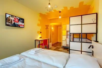 Un ou plusieurs lits dans un hébergement de l'établissement MEININGER Hotel Lyon Centre Berthelot