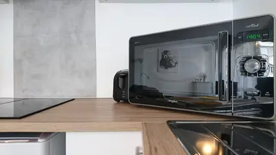 Cuisine ou kitchenette dans l'établissement Grand studio confort, Parking