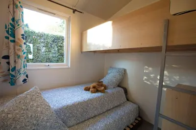 Un ou plusieurs lits dans un hébergement de l'établissement Camping La Grappe Fleurie