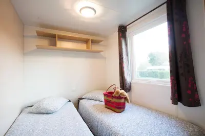 Un ou plusieurs lits dans un hébergement de l'établissement Camping La Grappe Fleurie