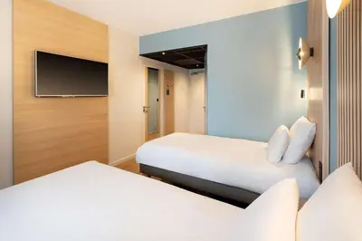 Un ou plusieurs lits dans un hébergement de l'établissement Best Western Bourgoin Jallieu