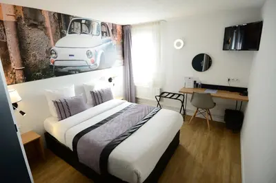 Un ou plusieurs lits dans un hébergement de l'établissement Logis Cris Hôtel et Restaurant, Lyon Sud-Est