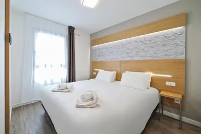 Un ou plusieurs lits dans un hébergement de l'établissement Residhotel Lyon Part Dieu