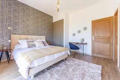 Un ou plusieurs lits dans un hébergement de l'établissement Gîte et chambres d'hôtes - La Maison du Grand Bossieu