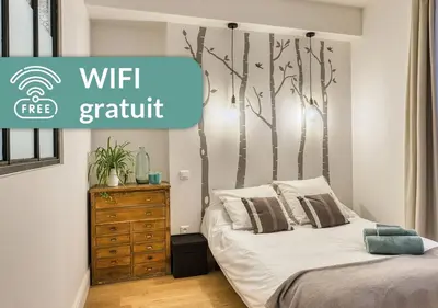 Un ou plusieurs lits dans un hébergement de l'établissement Cosy Appartement Lyon Valmy - parking