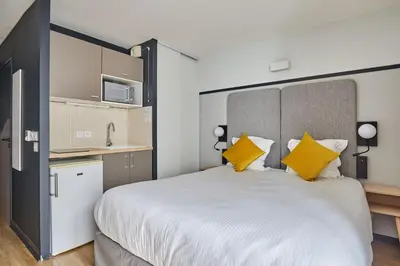 Un ou plusieurs lits dans un hébergement de l'établissement Appart'hôtel Odalys City - Lyon Centre Confluence