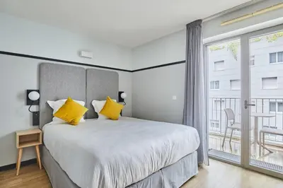 Un ou plusieurs lits dans un hébergement de l'établissement Appart'hôtel Odalys City - Lyon Centre Confluence
