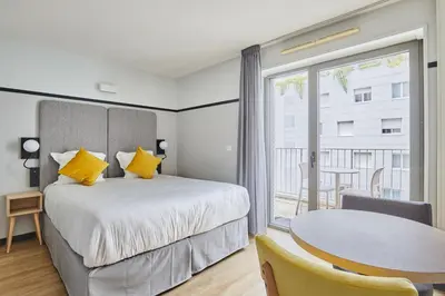 Un ou plusieurs lits dans un hébergement de l'établissement Appart'hôtel Odalys City - Lyon Centre Confluence