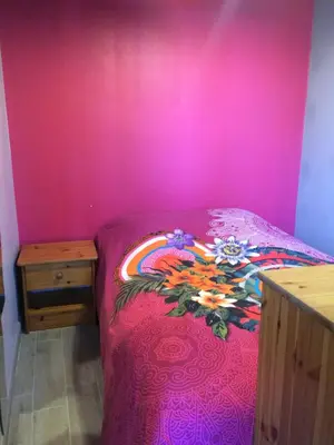 Un ou plusieurs lits dans un hébergement de l'établissement CHAMBRE CHEZ L' HABITANT SECTEUR LA RIZE