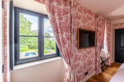 Un ou plusieurs lits dans un hébergement de l'établissement Hôtel Villa Alexandre