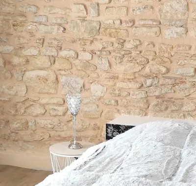 Un ou plusieurs lits dans un hébergement de l'établissement Appartement Theizé - Les meublés des Pierres Dorées