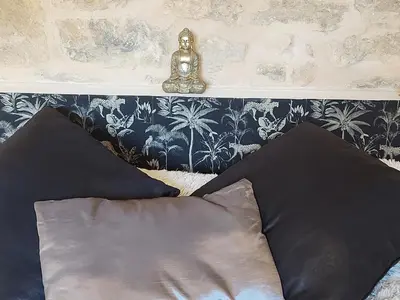 Un ou plusieurs lits dans un hébergement de l'établissement Appartement Jarnioux - Les Meublés des Pierres Dorées