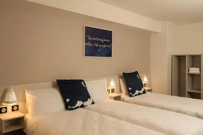Un ou plusieurs lits dans un hébergement de l'établissement ACE Hôtel Lyon Vénissieux Parc des Expositions