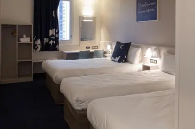 Un ou plusieurs lits dans un hébergement de l'établissement ACE Hôtel Lyon Vénissieux Parc des Expositions