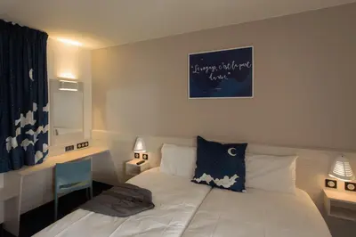 Un ou plusieurs lits dans un hébergement de l'établissement ACE Hôtel Lyon Vénissieux Parc des Expositions