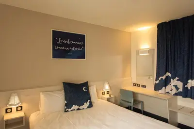 Un ou plusieurs lits dans un hébergement de l'établissement ACE Hôtel Lyon Vénissieux Parc des Expositions