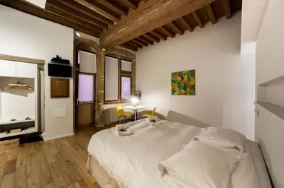 Un ou plusieurs lits dans un hébergement de l'établissement Le Petit Change - Studio tout équipé à Lyon AIL
