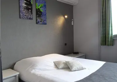 Un ou plusieurs lits dans un hébergement de l'établissement Europa Hotel