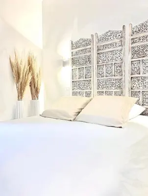 Un ou plusieurs lits dans un hébergement de l'établissement L’Escale - Le Boho + garage + NETFLIX