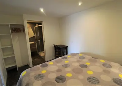 Un ou plusieurs lits dans un hébergement de l'établissement Gîte Sous le Marronnier aux portes de Lyon