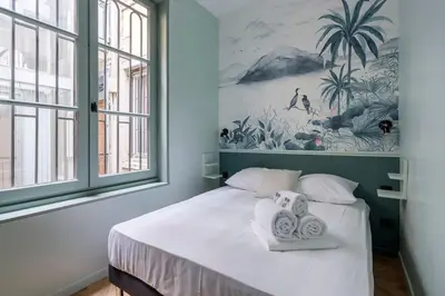 Un ou plusieurs lits dans un hébergement de l'établissement HAMAC Suites Suite St Antoine 2 CH Unique