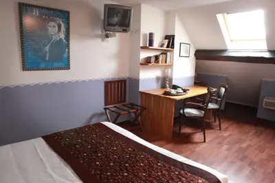 Un ou plusieurs lits dans un hébergement de l'établissement Hotel des Celestins