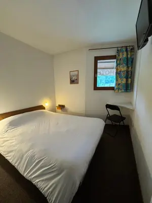 Un ou plusieurs lits dans un hébergement de l'établissement Symp'Hotel