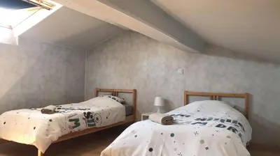Un ou plusieurs lits dans un hébergement de l'établissement Bald'Home côté jardin