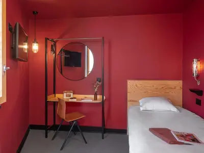 Un ou plusieurs lits dans un hébergement de l'établissement Eklo Hotels Lyon