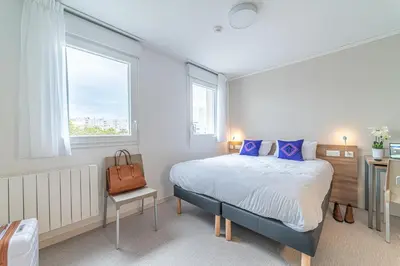 Un ou plusieurs lits dans un hébergement de l'établissement Montempô Appart'hôtel Lyon Viviani